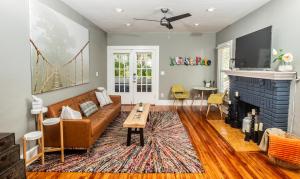 a living room with a couch and a fireplace at C'est La Vie - make memories at our cozy bungalow in St Petersburg
