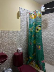 a bathroom with a shower curtain with a toilet at Guiltor host in Chachapoyas +35 photos
