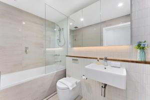 un bagno con un water, un lavandino e uno specchio di Waterview Apartment a Shellharbour