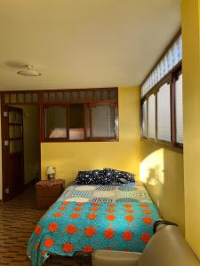 a bedroom with a bed with a colorful blanket at Guiltor host in Chachapoyas