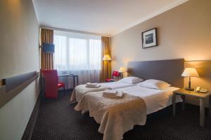 Łóżko lub łóżka w pokoju w obiekcie Hotel New Skanpol