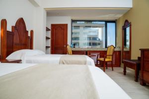 a hotel room with three beds and a bar at Vallarta Live Hotel in Puerto Vallarta +41 photos