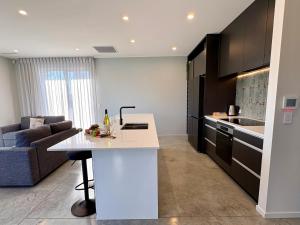 a kitchen with a white island in a room at OHAU I Love 15 in Twizel