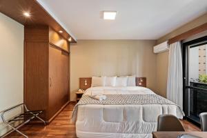Postel nebo postele na pokoji v ubytování Suite INSIDE Interative Jardins