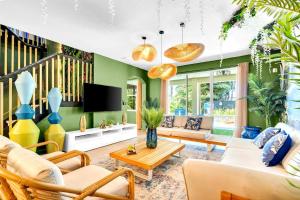 a living room filled with furniture and a tv at Avatar Miami Villa - Heated Pool & Spa - Pickleball & Cinema in Hammocks