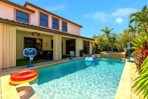 a swimming pool with a frisbee and a house at Avatar Miami Villa - Heated Pool & Spa - Pickleball & Cinema in Hammocks