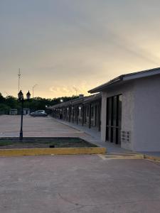 an empty parking lot next to a building at Sunset Inn in Brady