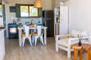 a kitchen and living room with a table and chairs at Apartamentos Alborada in La Paloma
