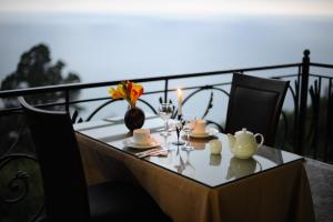 a table with a tea set on a balcony at Mount Villa Kvariati in Kvariati