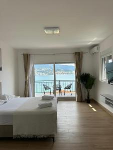 a bedroom with a bed and a view of the ocean at Bellanti in Herceg-Novi