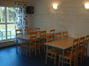 a dining room with wooden tables and chairs at Tuksi Health and Sports Centre in Tuksi