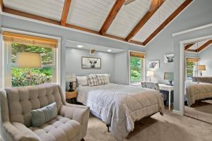 a bedroom with a bed and a couch and windows at Mountain View 3BDR with Hot Tub, Game Loft and Deck in Sugar Mountain
