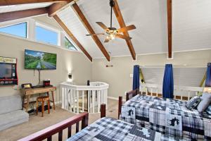 a bedroom with two beds and a ceiling fan at Mountain View 3BDR with Hot Tub, Game Loft and Deck in Sugar Mountain