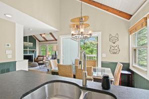 a kitchen with a sink and a living room at Mountain View 3BDR with Hot Tub, Game Loft and Deck in Sugar Mountain
