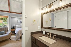 a bathroom with a sink and a mirror at Mountain View 3BDR with Hot Tub, Game Loft and Deck in Sugar Mountain +55 photos