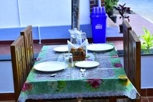 a table with plates and a glass jar on it at River Valley Retreat Coorg in Madikeri