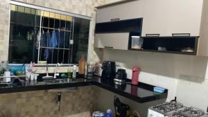 a kitchen with a sink and a counter top at Casa para Rondônia Rural Show in Ji-Paraná