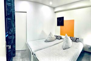 a bedroom with a bed with pillows on it at Contemporary house stadium of france in Saint-Denis