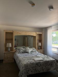 a bedroom with a large bed and a window at Motel Le Villageois Du Lac in Saint-Francois-du-Lac