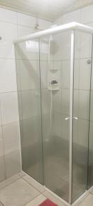 a shower with a glass door in a bathroom at Casa Lagoa Santo Antônio in Laguna