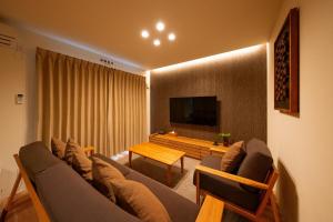 a living room with a couch and a table at Kitasaito Terrace C in Asahikawa