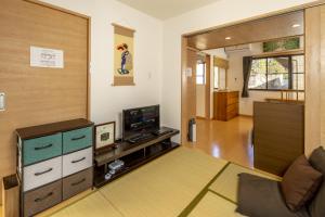 a living room with a couch and a television at Hibiki in Gionmachi
