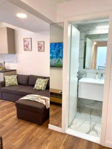 a living room with a couch and a mirror at Courtyard Flats House URBAN STAY in Zagreb