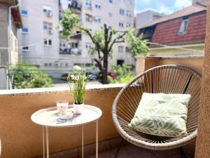 a couple of chairs and a table on a balcony at Courtyard Flats House URBAN STAY in Zagreb