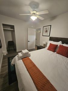 a bedroom with a large bed with a ceiling fan at Aansel Suites 2 bedroom in Edmonton +3 photos