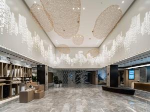 a lobby with a chandelier in a building at Atour Hotel Suzhou New District Huaihai Street in Suzhou