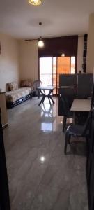a living room with a couch and a table at Location saisonnière in Settat