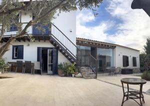 a patio with a staircase and a house at The Family Nest - Traditional Serenity in Orounda