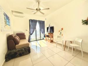 a living room with a couch and a table at HomeSweetHome-Seaview & Pool view in Perai