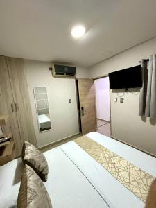 a hotel room with a bed and a television at GRAN HORIZON RODADERO Santa Marta in Santa Marta
