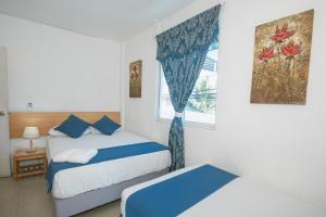 Postel nebo postele na pokoji v ubytování Hotel Casa Latina
