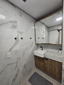 a bathroom with a sink and a mirror at Studio Aconchegante - Moema in Sao Paulo