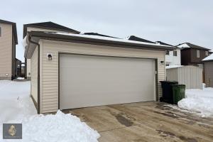 a garage with a large white garage door at FreshModernWEMGarageKingBed in Edmonton