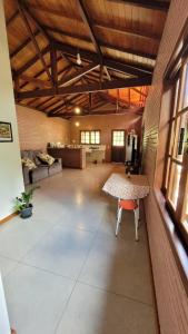 Habitación grande con mesa y silla. en Casa charmosa no centro de São Pedro da Serra, en Nova Friburgo