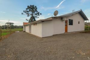 a large white building with a satellite at Hotel e hospedagem Alma de Campo in Rio Rufino +28 photos