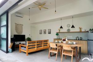 a kitchen and dining room with a table and chairs at Tranquil 2BR Pool Villa - Fast WiFi - Work-Friendly - Near Echo Beach in Tumbak Bayuh