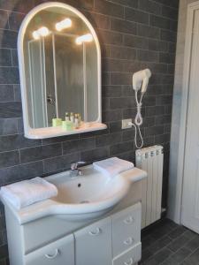a bathroom with a sink and a mirror at Hotel Baia Del Sole in Civitavecchia