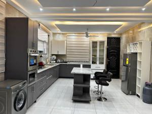 a kitchen with a washer and dryer in it at Nanani Luxury Villa - 3 Bedrooms in Kumasi