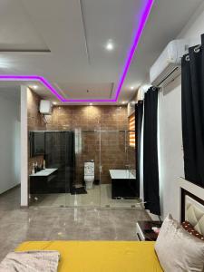 a bathroom with purple lights on the ceiling at Nanani Luxury Villa - 3 Bedrooms in Kumasi