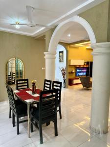 a dining room with a table and chairs at Nanani Luxury Villa - 3 Bedrooms in Kumasi +38 photos