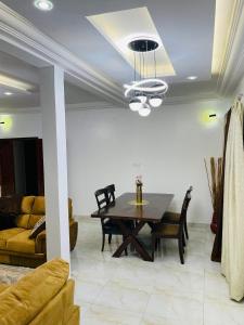 a dining room with a table and a couch at Mayna House in Dakar