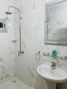 a white bathroom with a sink and a shower at Mayna House in Dakar +37 photos