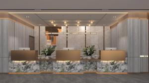 a lobby of a hotel with a chandelier at HARRIS Hotel & Suites Nagoya Batam in Nagoya