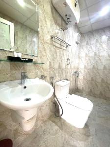 Un baño con lavabo blanco y inodoro. en Newlife Hạ Long -Homestay, en Ha Long 11 fotos más