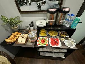 a table with many different types of food on it at La Renta Hotel & Spa in Hanoi