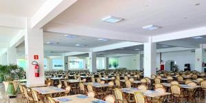 an empty banquet hall with tables and chairs at L'acqua Diroma - o Melhor de Caldas - Com Piscinas de Ondas in Caldas Novas
